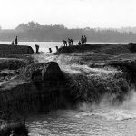 Cutting away the cofferdam at the Montlake Cut between Lake Washington and Lake Union. December 1913. Photographer unknown.