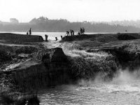 Cutting away the cofferdam at the Montlake Cut between Lake Washington and Lake Union. December 1913. Photographer unknown.