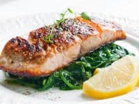 Grilled salmon with spinach, lemon and thyme photo by rafalstachura - DepositPhotos.com