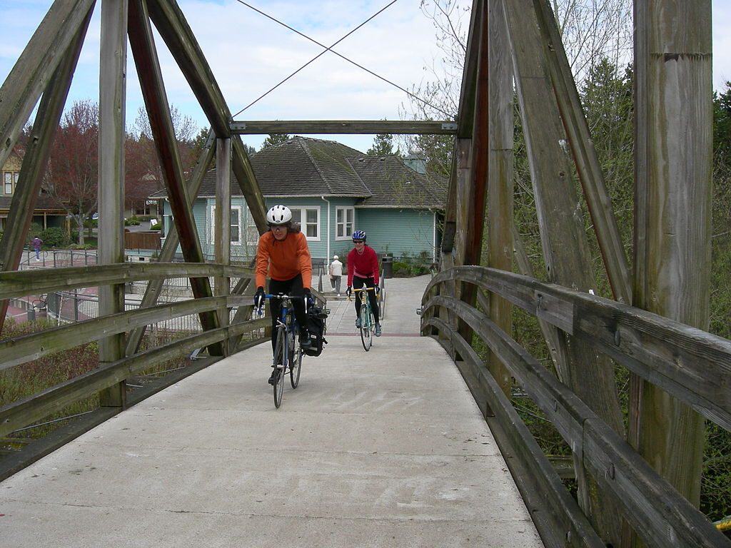 Bicyclists crosssing the bridge at Bothel Landing to the Burke-Gilman Trail photo by Joe Mabel (CC3)