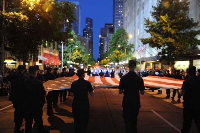 Coast Guardsmen and Coast Guard Auxiliary members from the Pacific Northwest march in Seattle's Torchlight Parade, July 30, 2011 photo by the Coast Guard [public domain]