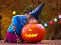 Young girl peers into a Halloween pumpkin