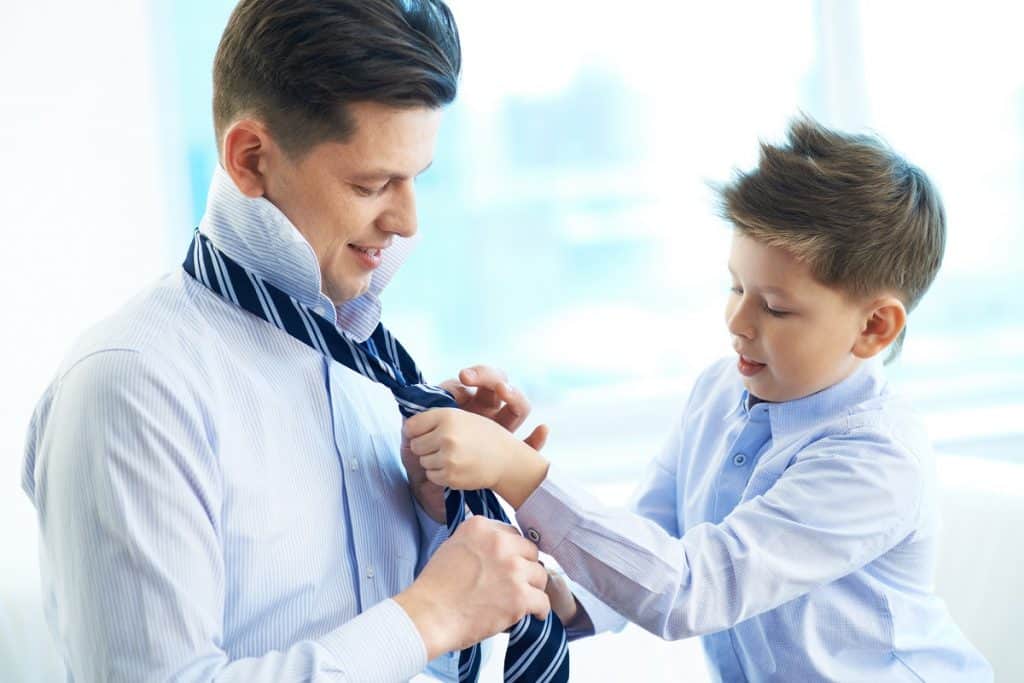 Father and son getting dressed