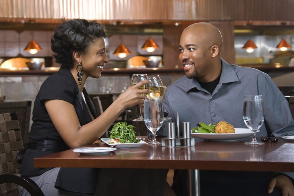 couple dining out clinking wine glasses
