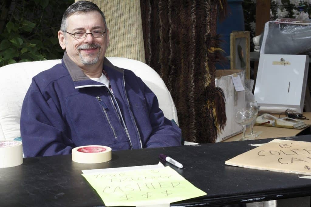 Male Cashier at a Garage Sale