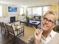 Woman daydreaming about home improvements - DepositPhotos.com