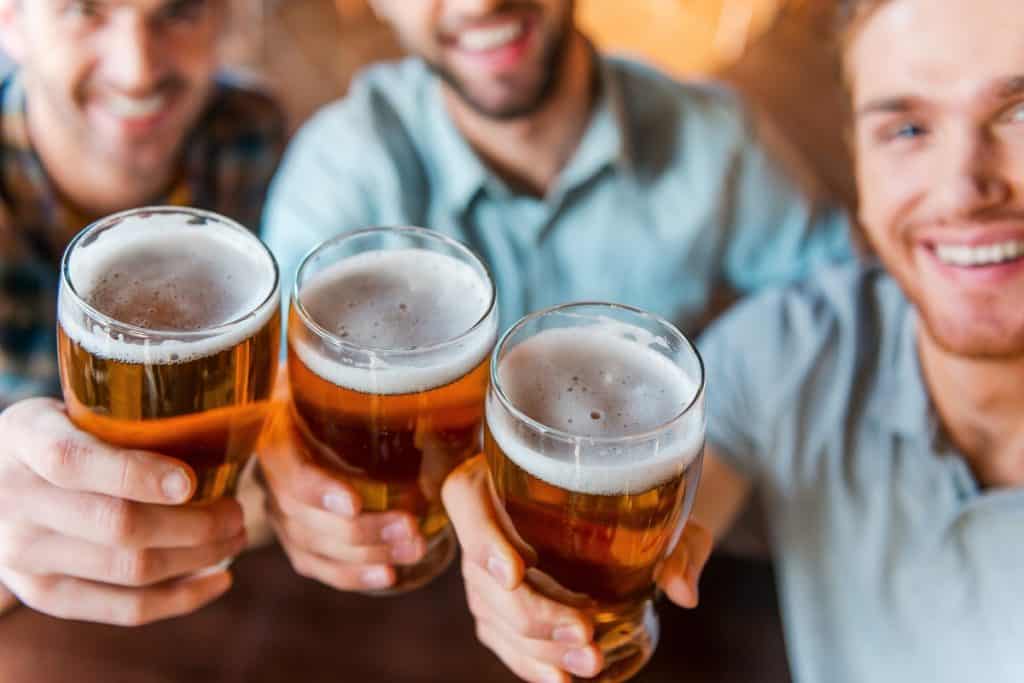 Men toasting with pints of beer