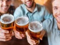 Men toasting with pints of beer