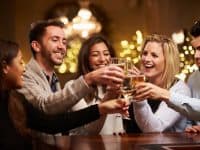 Group Of Friends Enjoying Drinks In Bar