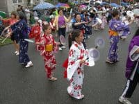 Dancing the Omikoshi Ondo (note the round fans) at Seafair Bon Odori Festival, Seattle, WA photo by Joe Mabel (CC3)