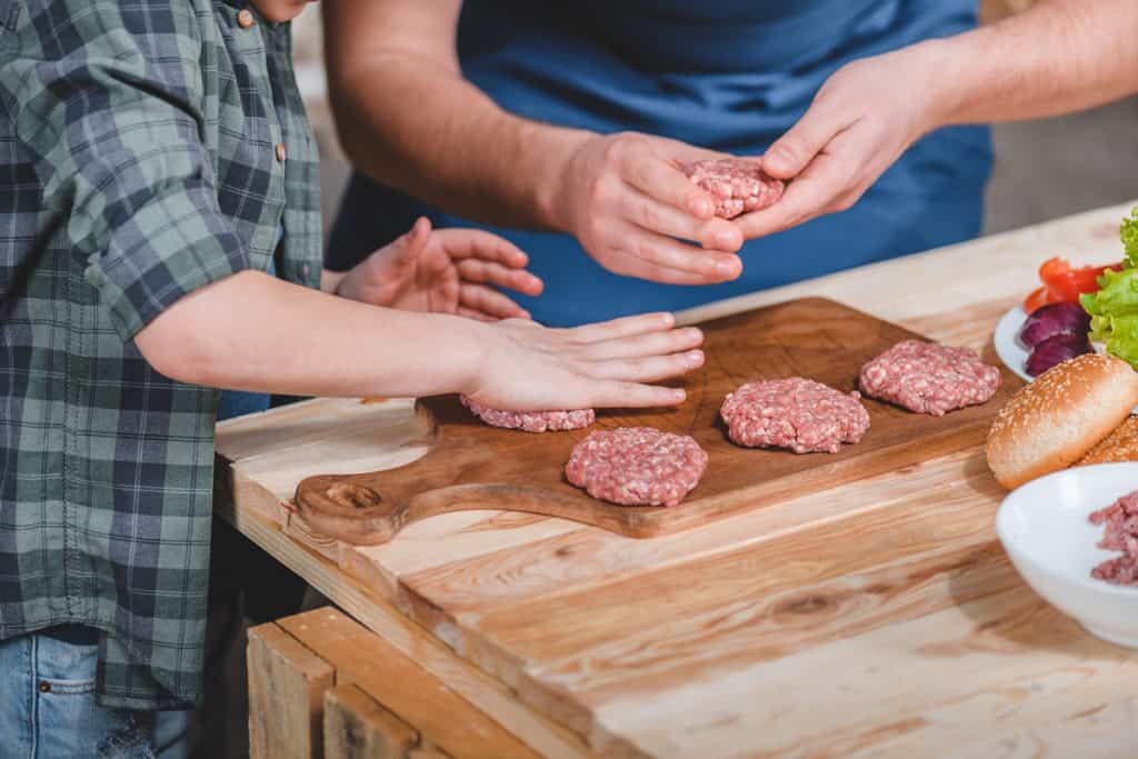 Father and son preparing burgers