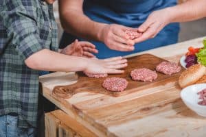 Father and son preparing burgers