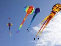 colorful flying kites - DepositPhotos.com