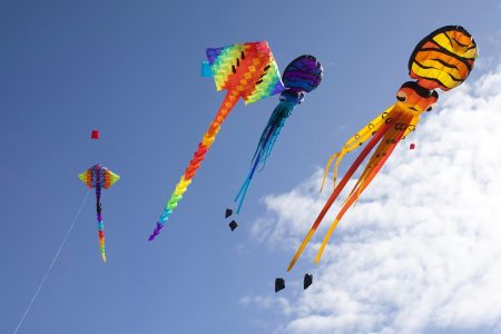 colorful flying kites - DepositPhotos.com