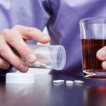 Man drinking alcohol and taking pills photo by photographee.eu - DepositPhotos.com