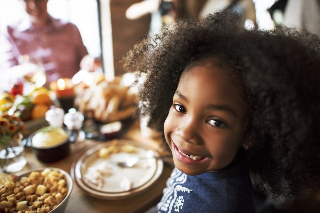 Happy young girl at Thanksgiving dinner
