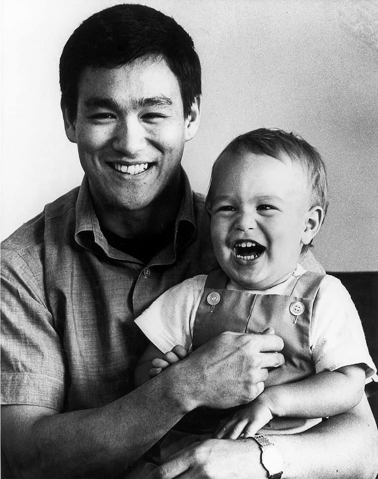 1966 Publicity photo of Bruce Lee with son Brandon. (public domain)