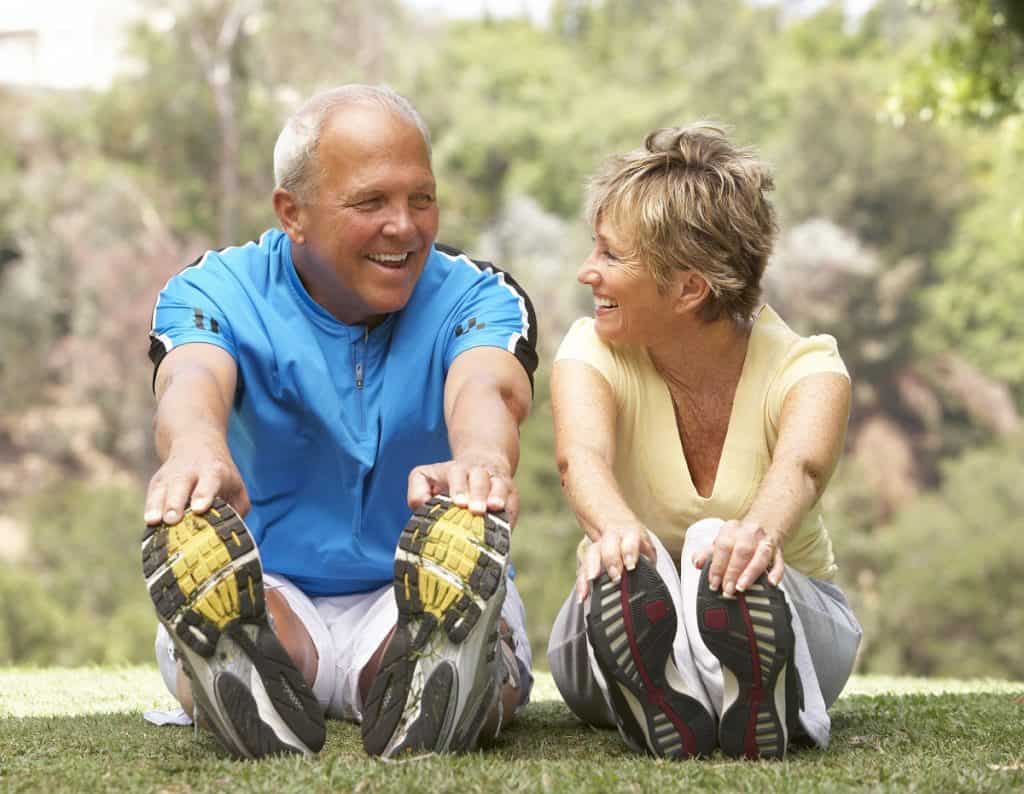 Senior Couple Exercising In Park