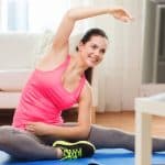 woman exercsing at home using a video - DepositPhotos.com