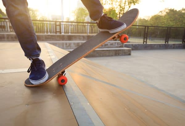 skateboarder at the top of a ramp in the park