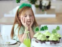 Young girl admiring St. Patrick's Day cupcakes