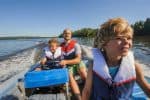 Father and sons out boating together.