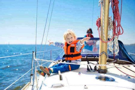 Happy kid on a sailboat