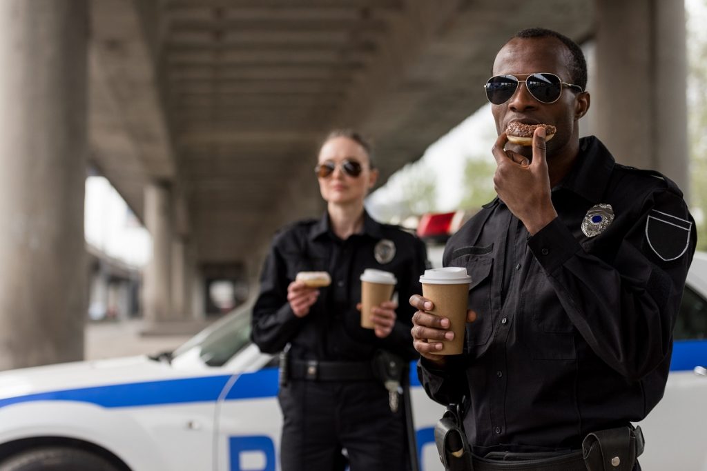 Police officers eating donuts