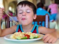 young boy enjoying food