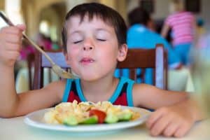young boy enjoying food
