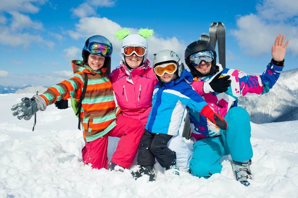 Family enjoying winter snow sports photo by mac_sim - DepositPhotos.com