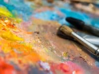 Oil paints and paint brushes on a palette photo by VBaleha - DepositPhotos.com