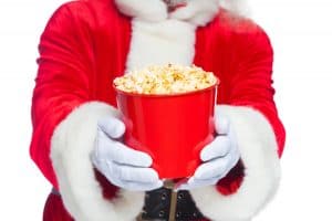 Santa Claus at the movies with bucket of poprcorn photo by satyrenko - Depositphotos.com