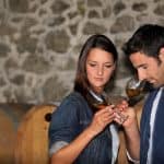 A couple wine tasting at a winery - DepositPhotos.com
