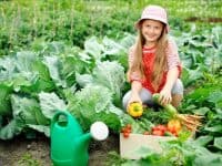 Young girl in a vegetable garden