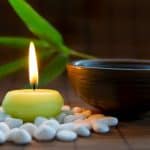 Candles, tea, and zen stones create harmony for meditation practice - DepositPhotos.com