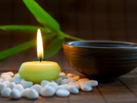 Candles, tea, and zen stones create harmony for meditation practice - DepositPhotos.com