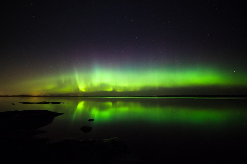 Northern lights over lake in finland