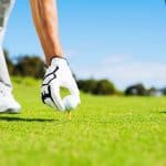 Man Placing Golf Ball on Tee