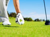 Man Placing Golf Ball on Tee
