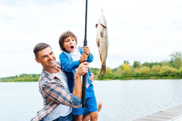 Father and daughter catching a fish