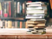 stack of used books on a store counter