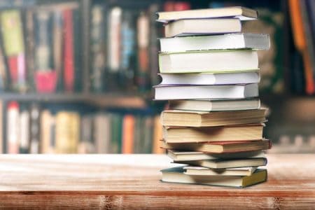 stack of used books on a store counter