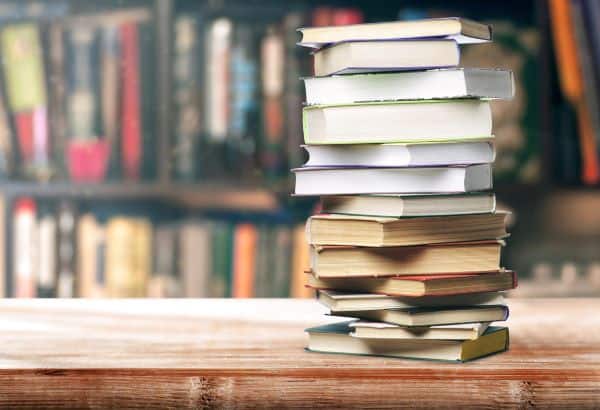 stack of used books on a store counter