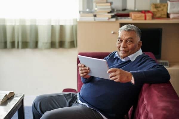 man using tablet computer at home