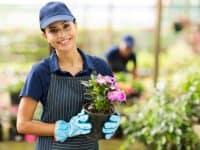 Nursery garden store owner with pots of flowers