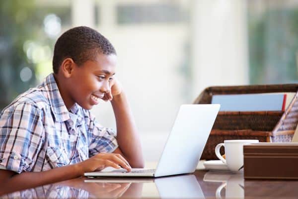 Young boy enjoying a computer session at home