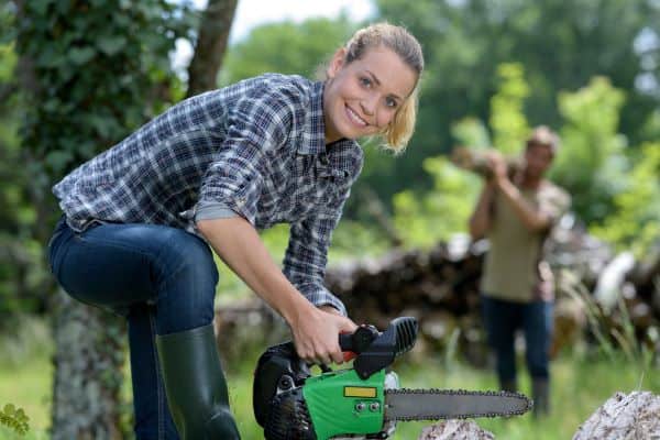 Woman using a chainsaw