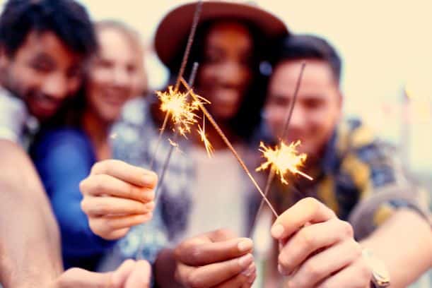 Groups of friends celebrating with sparklers