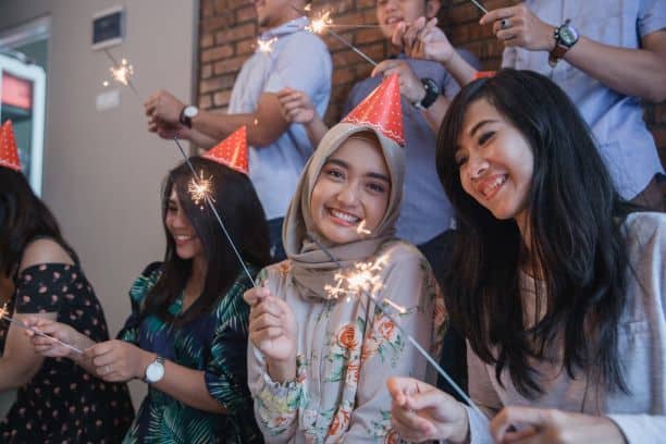 Group of friends celebrating with sparklers
